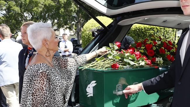 Family members place flowers on the casket during the funeral for Souths legend John Sattler on the Gold Coast. Picture: NCA NewsWire/Tertius Pickard