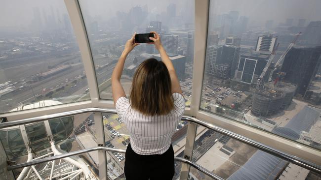 Maria Constas views the smoke haze hitting Melbourne from the Melbourne Star Observation Wheel Picture: David Caird