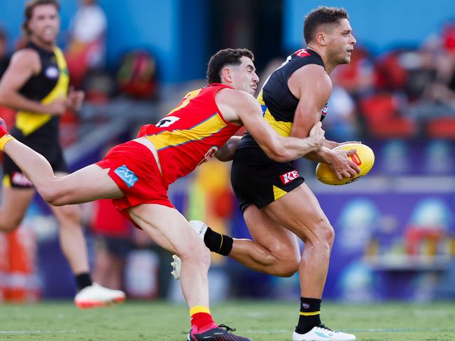 Tiger Dion Prestia gets caught by Sam Flanders. Picture: Dylan Burns/AFL Photos