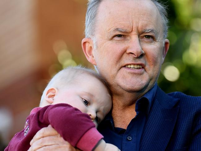 BRISBANE, AUSTRALIA - NewsWire Photos - JUNE 9, 2021.Federal Opposition Leader Anthony Albanese holds Dash, the son of the Member for Lilley, Anika Wells (right), during a press conference outside the Prince Charles Hospital in Brisbane. Picture: NCA NewsWire / Dan Peled