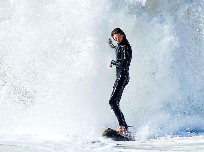 A surfer is dwarfed by whitewater at Sunshine Beach as a southerly swell from an east coast low pushes big waves into south east Queensland. Photo Lachie Millard