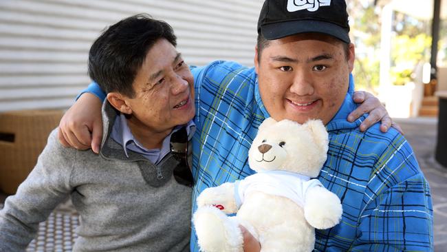 DoSomething Day 2017. L to R Father, Calvin Duong and son Peter Duong. St Johns Park, Wednesday, July 19, 2017. Share Care volunteers (assisting children with disabilities) have made teddy bears for their favourite person. (AAP Image/Angelo Velardo)