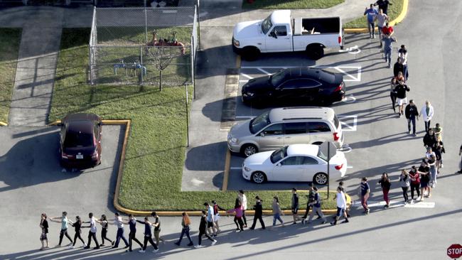 Students are evacuated by police from Marjorie Stoneman Douglas High School in Parkland. Picture: Orlando Sentinel.