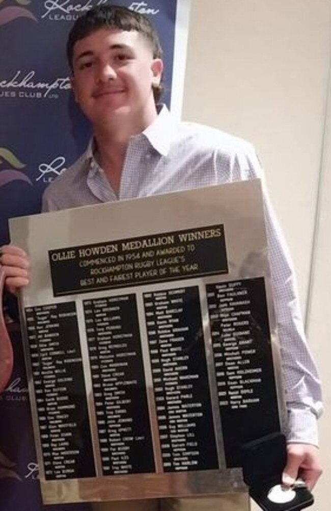 Emu Park Harry Barham with the Ollie Howden Medal honour board.