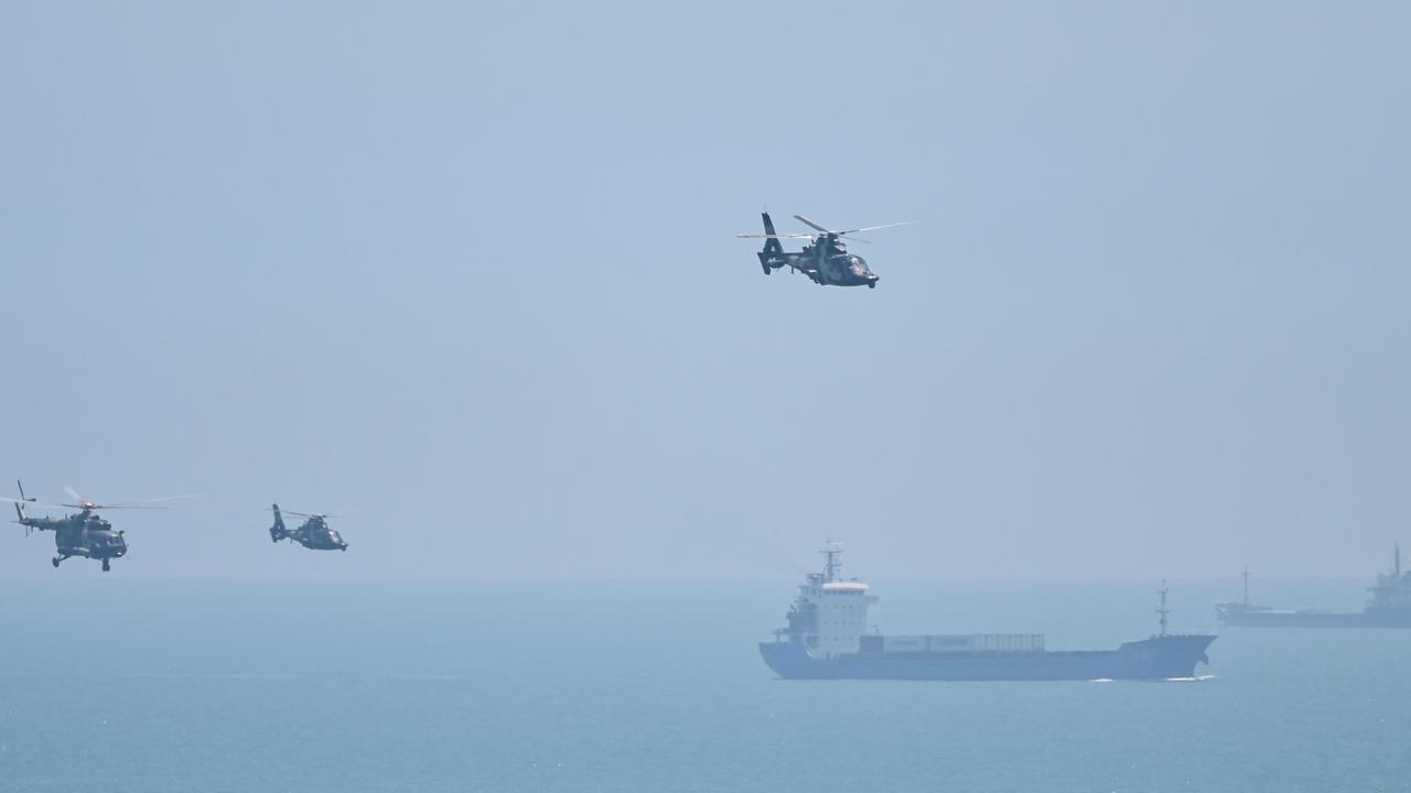 Chinese military helicopters fly past Pingtan island, one of mainland China's closest point from Taiwan, ahead of massive military drills off Taiwan following US House Speaker Nancy Pelosi's visit to the self-ruled island. Picture: Hector Retamal/AFP