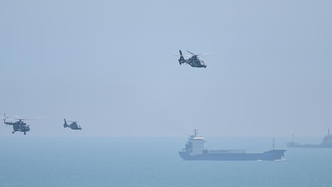 Chinese military helicopters fly past Pingtan island, one of mainland China's closest point from Taiwan, ahead of massive military drills off Taiwan following US House Speaker Nancy Pelosi's visit to the self-ruled island. Picture: Hector Retamal/AFP