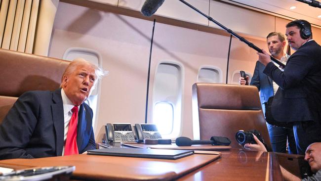 Donald Trump speaks to the press on board Air Force One. Picture: AFP.