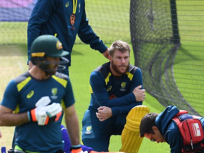 Australia's David Warner (C) looks on as an injured net bowler receives medical attention during a training session at The Oval in London on June 8, 2019, ahead of their match of the 2019 Cricket World Cup against India. (Photo by Dibyangshu SARKAR / AFP) / RESTRICTED TO EDITORIAL USE