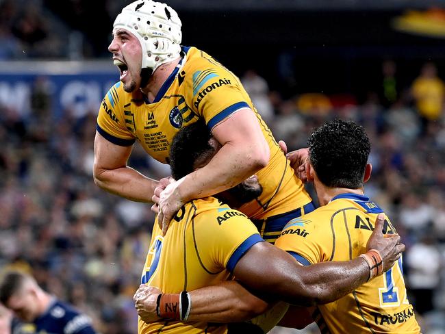 Maika Sivo of the Eels celebrates a try with teammates Bailey Simonsson and Reed Mahoney on the way to victory — and winning a grand final berth — over North Queensland. Picture: Bradley Kanaris/Getty Images