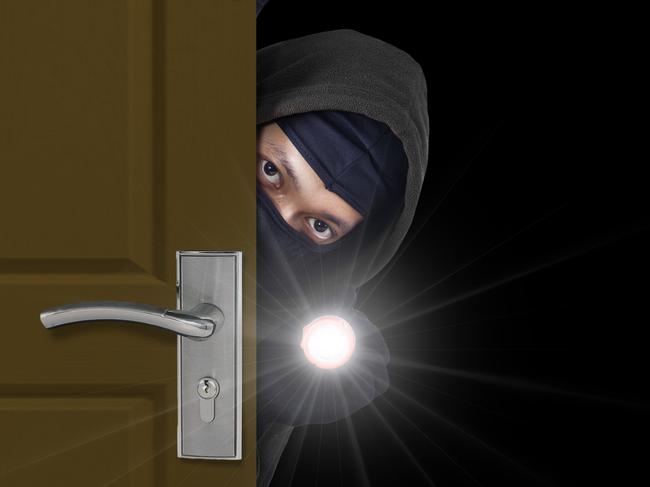 Burglar sneaking in a open house door during a break and enter past security locks and alarms, theft generic