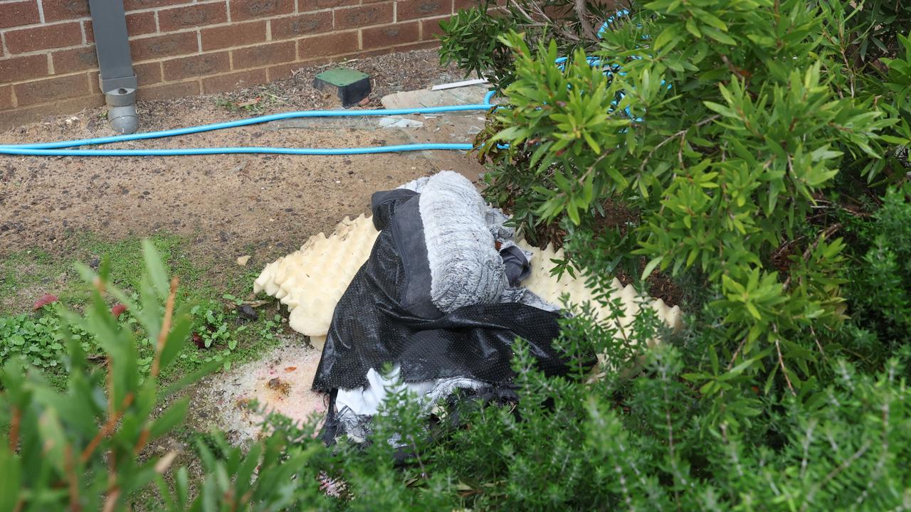 An item appearing to be a damaged pet bed was seen underneath a boarded up window on the first floor of the house.