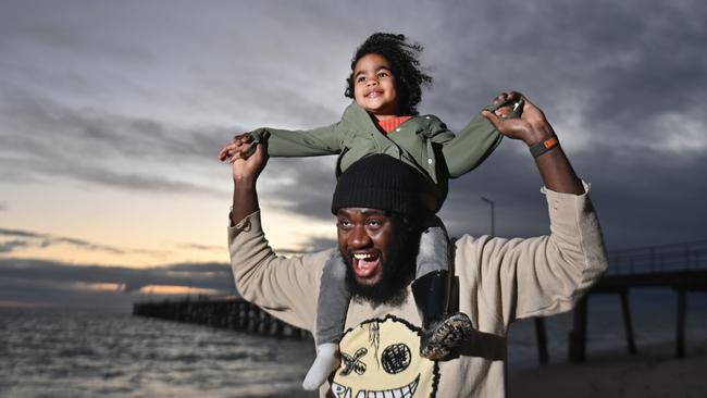 Jurgen Boahen-Oteng with his daughter Eris, 2, at Port Noarlunga Beach. Picture: Keryn Stevens