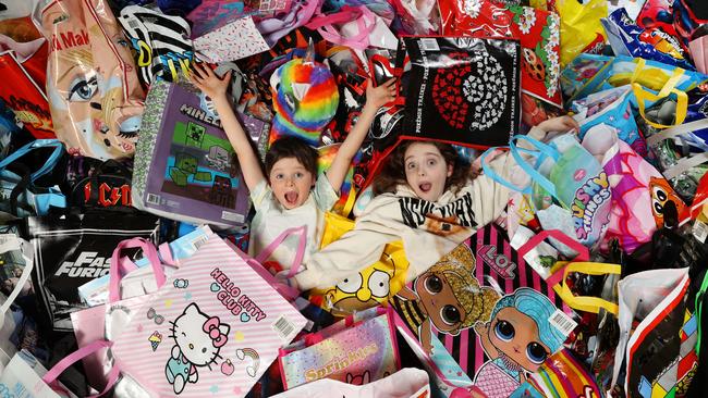 Siblings Harry, 6, and Cate, 9, work their way through all the showbags on offer at this year’s Melbourne Royal Show. Picture: David Caird