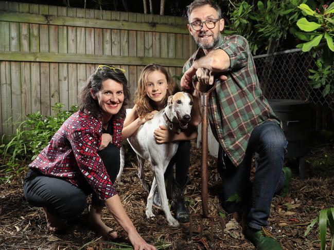 Rob Pekin with his partner Emma-Kate Rose and their daughter Elsie with pet greyhound Angel in their compost garden at home. Picture: Lachie Millard