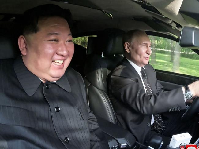 TOPSHOT - This picture taken on June 19, 2024 and released on June 20, 2024 from North Korea's official Korean Central News Agency (KCNA) via KNS shows North Korea's leader Kim Jong Un (L) sitting in the passenger seat of a car driven by Russia's President Vladimir Putin (R) in the garden of the Kumsusan State Guesthouse in Pyongyang. (Photo by KCNA VIA KNS / AFP) / South Korea OUT / ---EDITORS NOTE--- RESTRICTED TO EDITORIAL USE - MANDATORY CREDIT "AFP PHOTO/KCNA VIA KNS" - NO MARKETING NO ADVERTISING CAMPAIGNS - DISTRIBUTED AS A SERVICE TO CLIENTS THIS PICTURE WAS MADE AVAILABLE BY A THIRD PARTY. AFP CAN NOT INDEPENDENTLY VERIFY THE AUTHENTICITY, LOCATION, DATE AND CONTENT OF THIS IMAGE. /