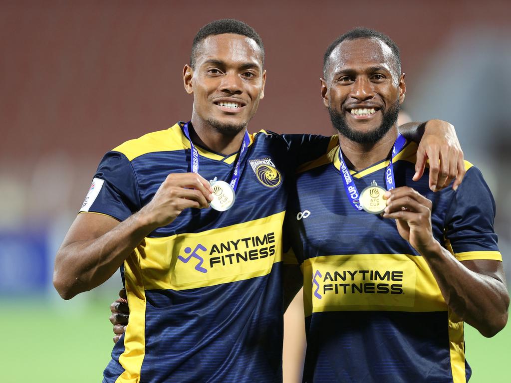 Central Coast Mariners' Fijian defender Dan Hall (L) and Ni-Vanuatu defender Brian Kaltak pose with their medals after winning the AFC Cup final football match between Lebanon's Al-Ahed and Australia's Central Coast Mariners at the Sultan Qaboos Sports Complex in Muscat on May 5, 2024. (Photo by Haitham AL-SHUKAIRI / AFP)