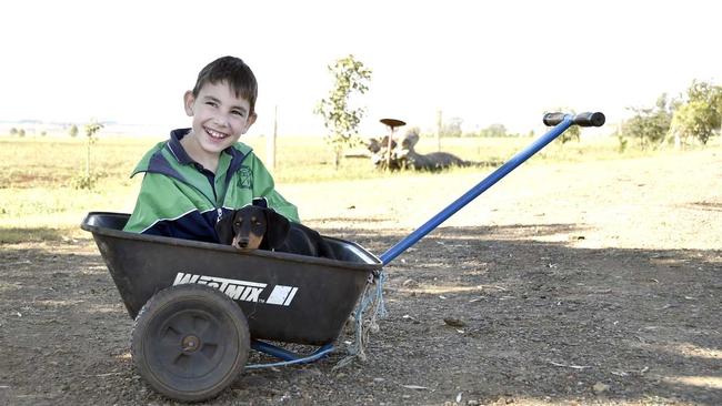 Angus Hopkins, from Nobby needs a new wheelchair but NDIS keeps stalling. His mother uses a wheelbarrow to move him around outside. April 2019. Picture: Bev Lacey