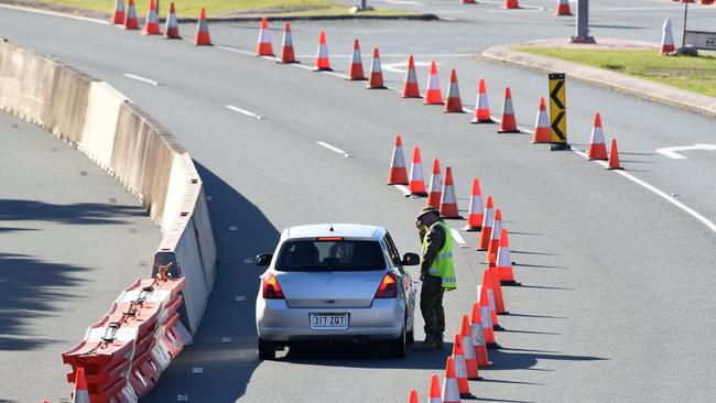 Police check cars at the Queensland border. Picture: Steve Holland