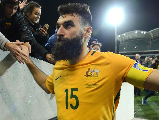 (FILES) This file photo taken on June 8, 2016 shows Australian captain Mile Jedinak leaving the field after their World Cup football Asian qualifying match against Saudi Arabia at the Adelaide Oval in Adelaide. Australia's hopes of qualifying for next year's World Cup have been dealt a blow after injury concerns forced skipper Mile Jedinak out of a 23-man squad to face Japan and Thailand in crunch qualifiers on August 23, 2017. / AFP PHOTO / BRENTON EDWARDS / --IMAGE RESTRICTED TO EDITORIAL USE - STRICTLY NO COMMERCIAL USE--