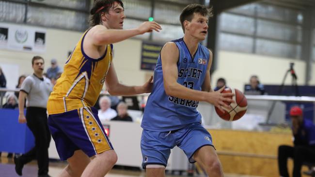 Sturt’s Taine Mitchell drives towards the basket in front of Forestville’s Mitchell Dix during the Adelaide Basketball Challenge match on Saturday. Picture: Dean Martin