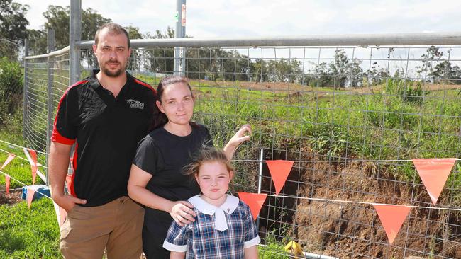 Raymond, Suzanne and their daughter Mia Phillips inspect the sinkhole on their street in Box Hill on February 24. Picture: AAP IMAGE / Angelo Velardo