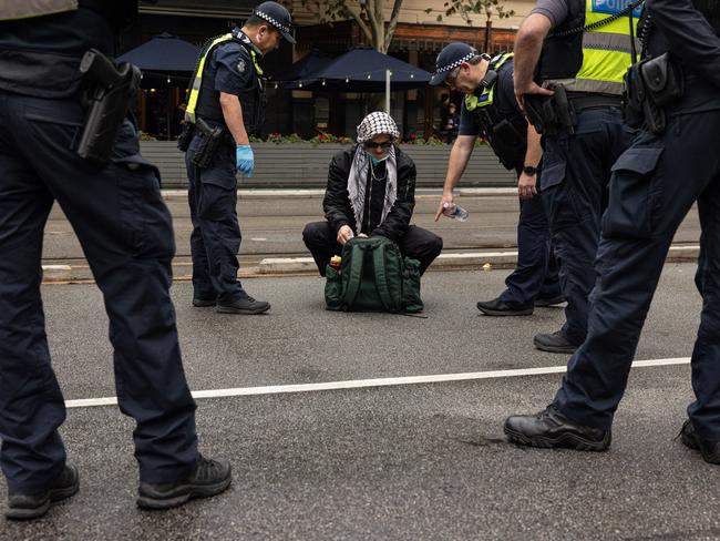 Members of Victoria Police search pro-trans activists. Picture: NewsWire / Diego Fedele