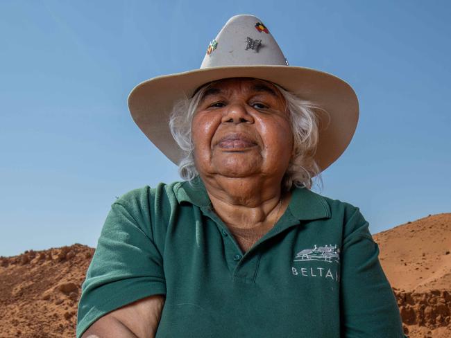 Beverley Patterson holding sacred upturned soil next to a borrow pit along the Hawker Graded Track. Pictured on September 15th 2023. Picture: Ben Clark