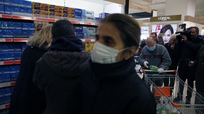 Shoppers wearing gloves and face masks in Athens on Monday. Picture: AP