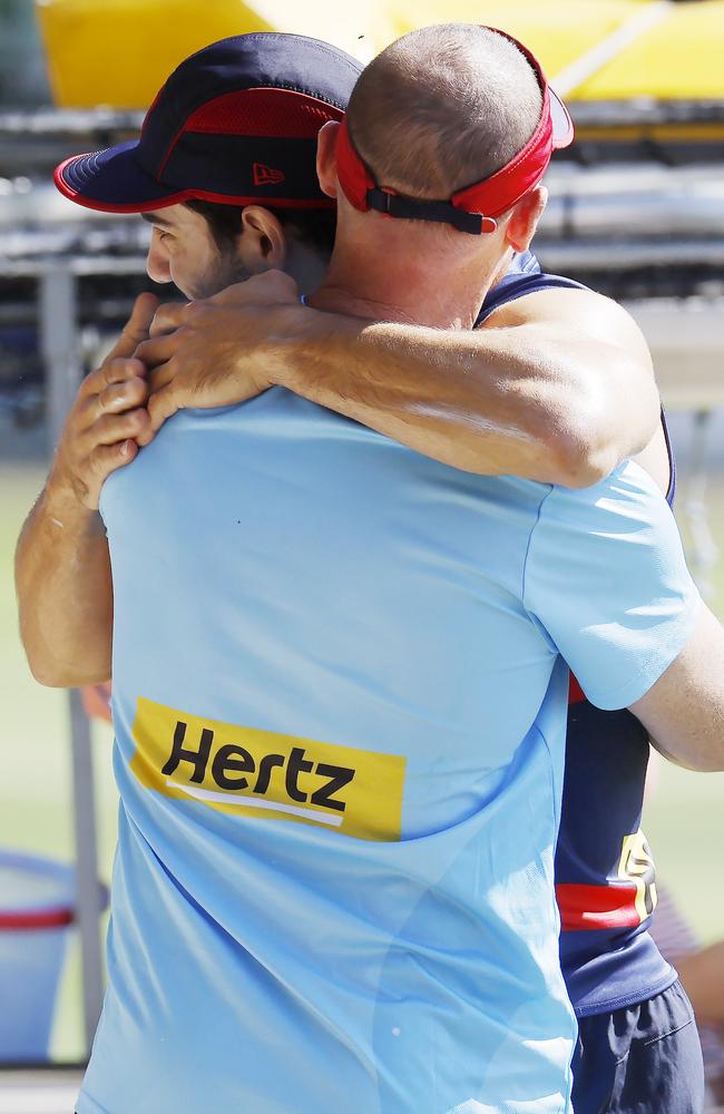 Petracca hugs coach Simon Goodwin on his return to training. Picture: Michael Klein