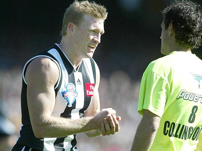 27/09/2003. Nathan Buckley talks tactics with the runner. 2003 Grand Final. Collingwood v Brisbane Lions. MCG. DIGITAL IMAGE