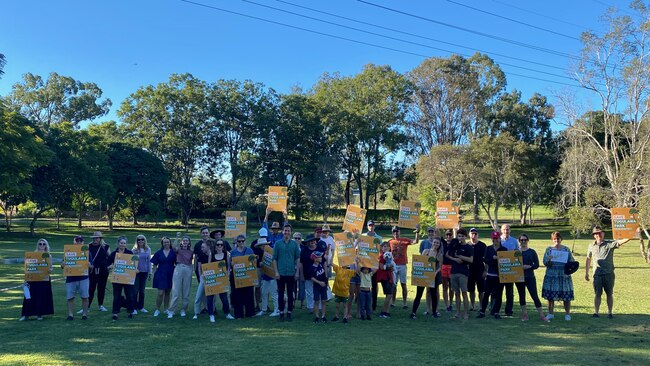 Bulimba residents at Tugulawa Park, lined up to the approximate width of the planned four-lane access road that would cut through the middle of the park.