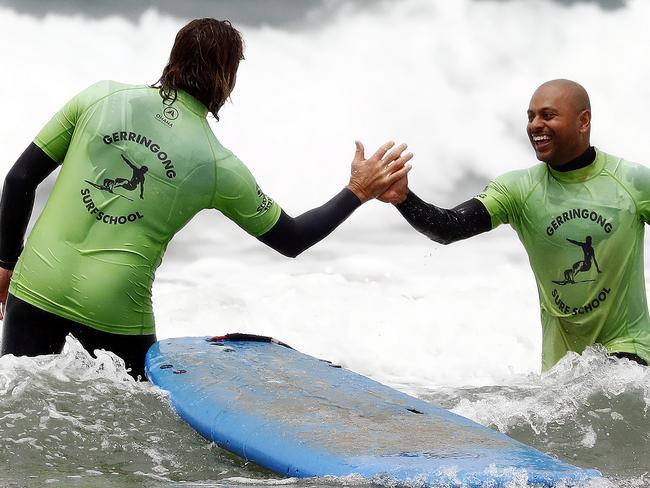 Andrew Singh gets a high-five after catching a wave. Picture: Sam Ruttyn