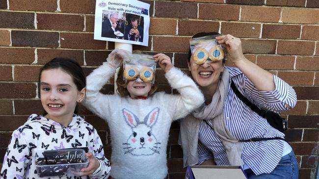 Charlotte Raven, Caitlin and Lauren Dunstan have fun at Panania Public School cake stall: . Picture: Lawrence Machado