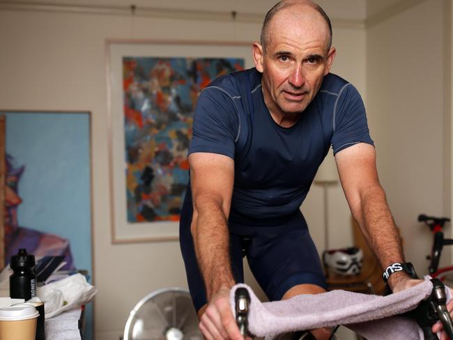 Veteran journalist Rupert Guinness rides a stationary bike in his Edgecliff home during training for the virtual Race Across America in June.