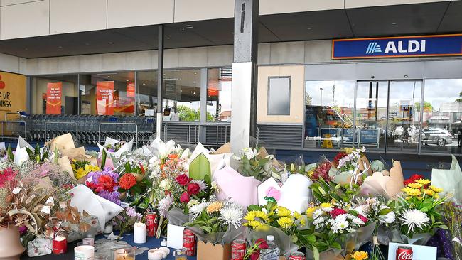 Flowers left outside the Redback Plains shopping centre where a grandmother was fatally stabbed. Picture: John Gass