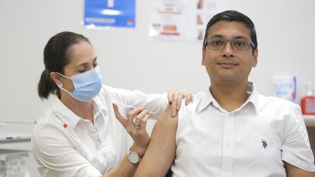 Dr. Niladri Ghosh becomes the first in the Wollongong area to receive to vaccine from Immunisation co-ordinator Natasa Veselinovic.