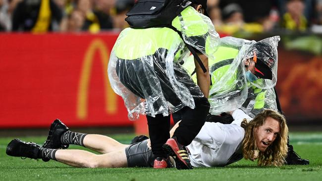 A moron who ran onto the Gabba was swiftly dealt with by security. Picture: Getty Images