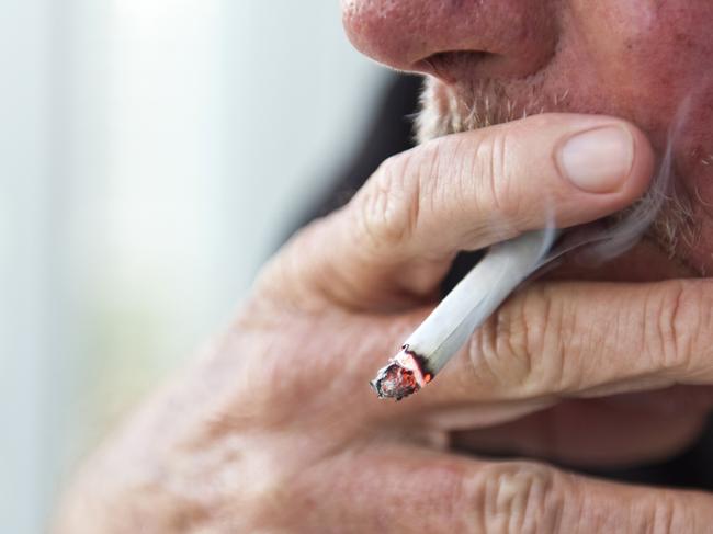 Caucasian old man smoking a cigarette