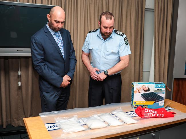 Tasmania Police’s Detective Acting Inspector Mathew Adams, left, and the Australian Federal Police’s Detective Sergeant Aaron Hardcastle with the seized drugs. Picture: Mireille Merlet