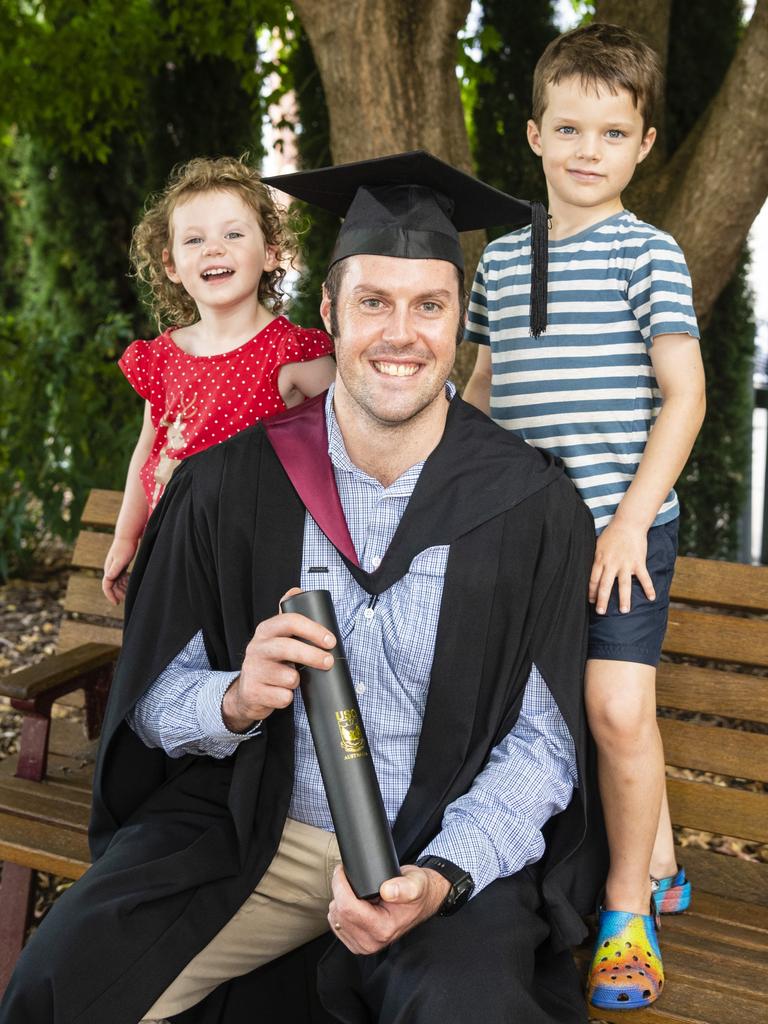 Bachelor of Spatial Science Technology (Surveying) (Honours) graduate Lewis Sweet with his kids Matilda and Arthur Sweet at the UniSQ graduation ceremony at Empire Theatres, Tuesday, December 13, 2022. Picture: Kevin Farmer