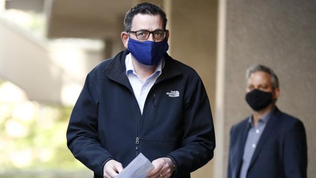 Victorian Premier Daniel Andrews wears a face mask as he walks in to the daily briefing on July 19.