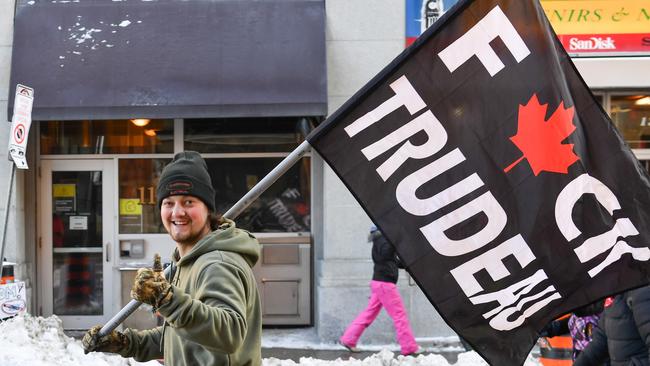 A protester holds up a flag showing his displeasure with the Covid mandates imposed by Trudeau. Picture: Minas Panagiotakis/Getty Images/AFP