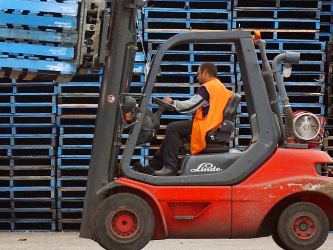 NOVEMBER 21, 2002: Forklift operator stacks empty wooden pallets at CHEP pallet depot in Sydney that is owned by Brambles Industries Ltd, 21/11/02 as investors hammered shares in group that are down more than 26. NSW / Industry