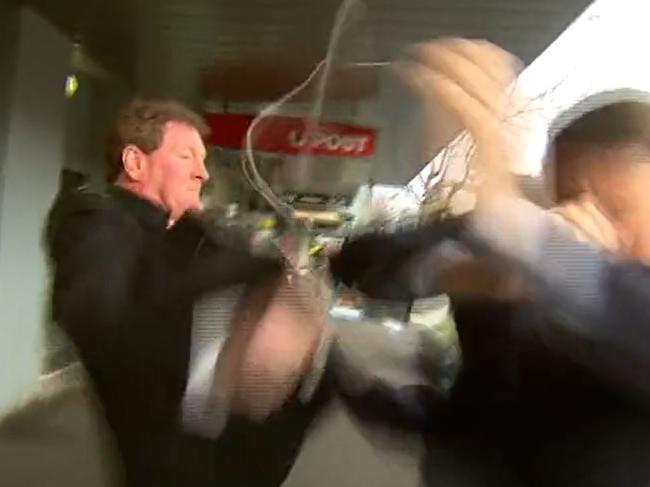 Ricky Nixon allegedly elbowing TV reporter Seb Costello in the jaw in an ugly confrontation on the streets of Port Melbourne. Picture: Channel 9