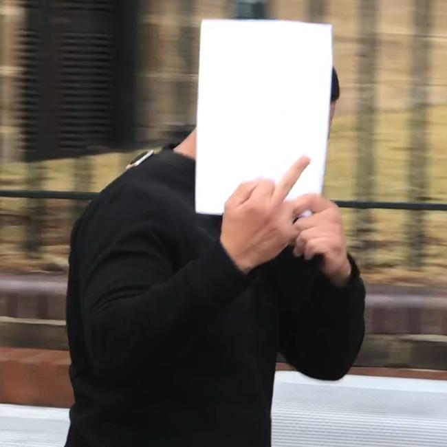 A camera-shy Mohamad Alameddine leaves Campbelltown Courthouse.