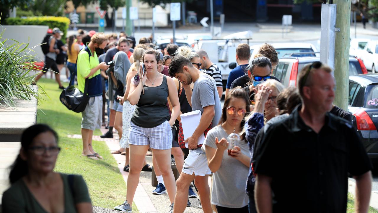 Lines of people wait at Southport Centrelink. Picture: Adam Head.