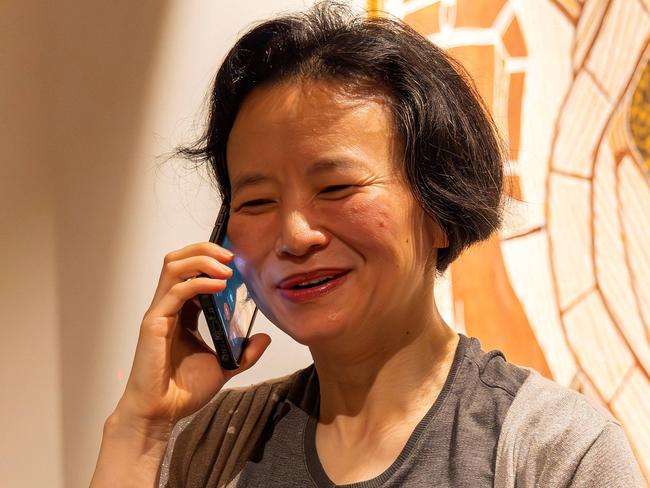 Cheng Lei makes a phone call after touching down in Melbourne.