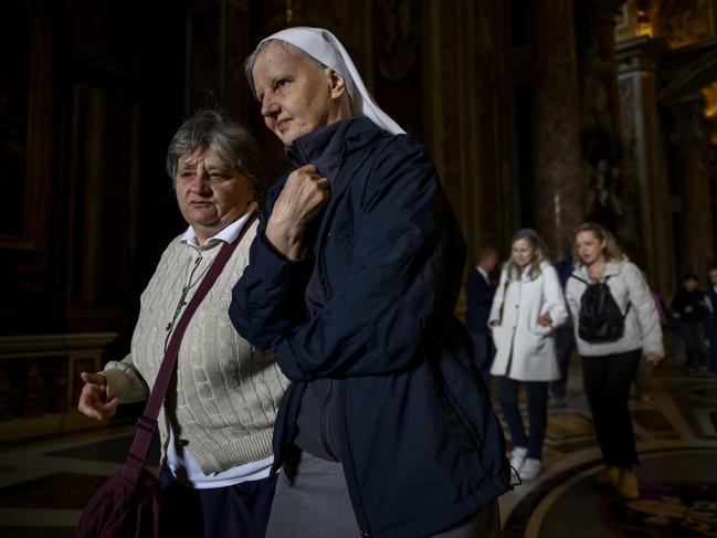 Faithful are emotional as they leave St Peter's Basilica. Picture: Getty Images