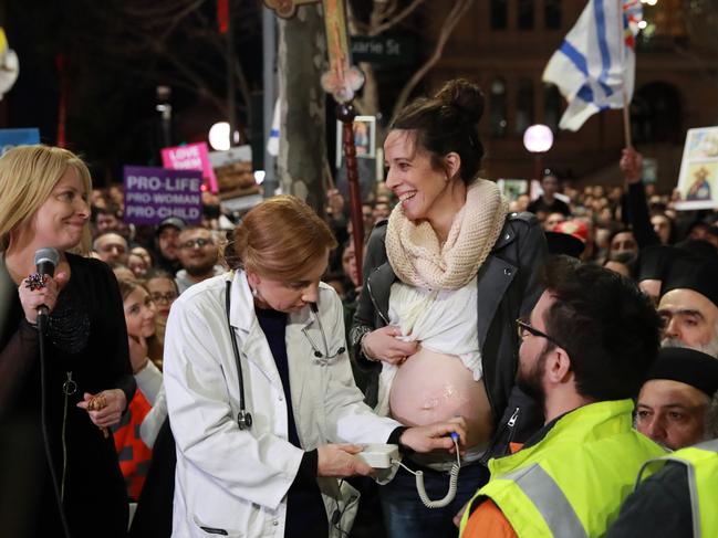 Protesters listen to the heartbeat of the unborn child of Chantal Czeczotko during a rally against the Reproductive Health Care Reform Bill 2019 in Martin Place on Tuesday. Picture: Justin Lloyd