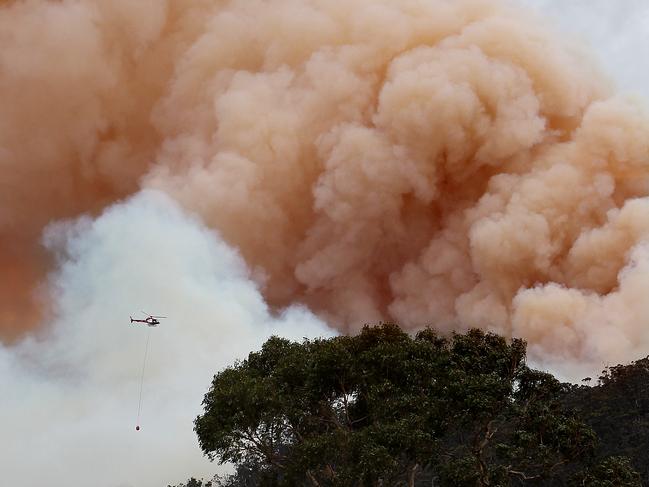 2013 Bushfires (Bush Fires) a helicopter drops water on a huge fire near Lachlan in the Derwent Valley